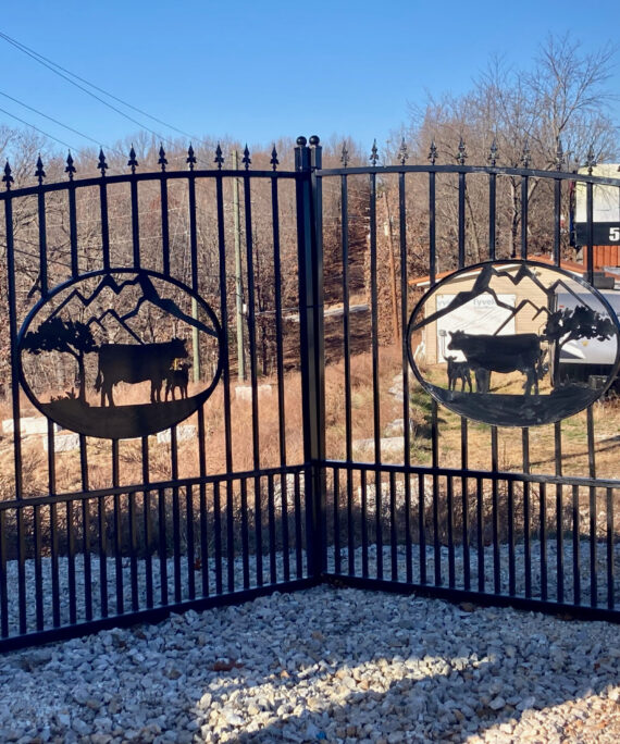 14 foot wrought iron style driveway gates with a cow calf scene in the center. Gates come with a black powder coated finish.