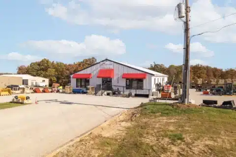 Angled front view of the building and gravel approach at 706 N Main St.