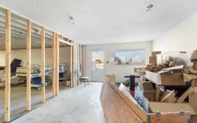Partially framed lower-level area with an exterior door and stored items.