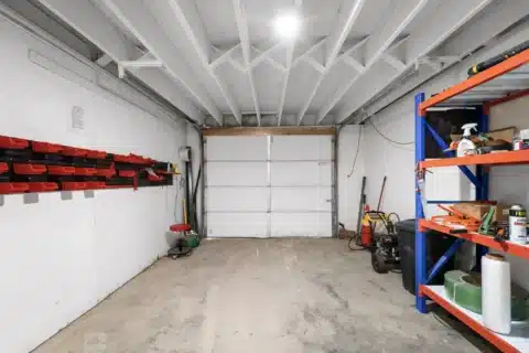 Lower-level storage bay facing a closed overhead garage door.