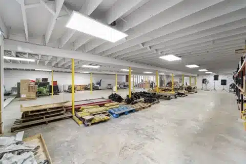 Wide view across the open lower-level storage and work floor.