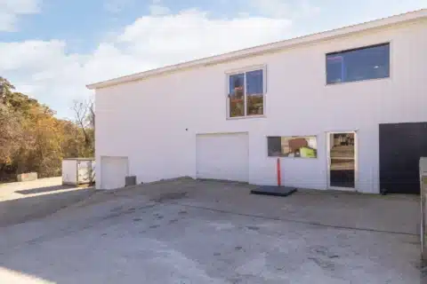 Rear elevation of 706 N Main St with overhead doors, a personnel door and loading area.