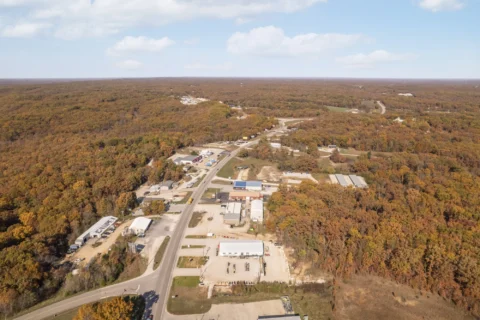 Aerial view along the road past 706 N Main St and neighboring properties.