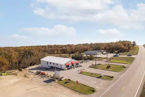 Oblique aerial view of 706 N Main St beside the main road.