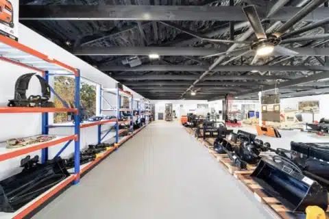 Long showroom aisle with shelving and open floor space.