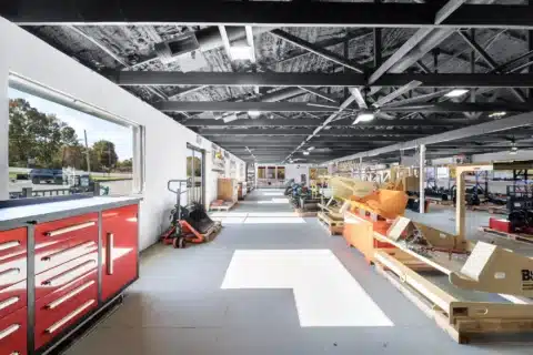 Long interior view through the bright showroom.