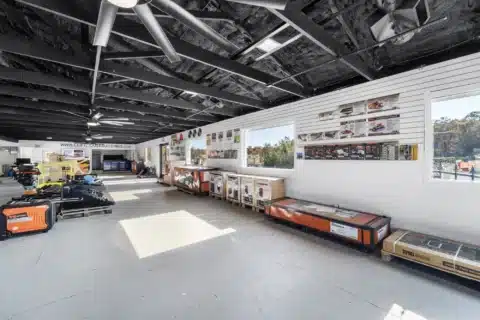 Showroom interior along a wall of large windows.