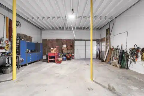 Workshop area with tool cabinets and a closed overhead garage door.