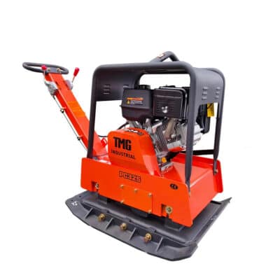 Orange plate compactor machine with a gas-powered engine for soil compaction, labeled TMG INDUSTRIAL PC325, with a gray base plate and handle frame, used in construction.