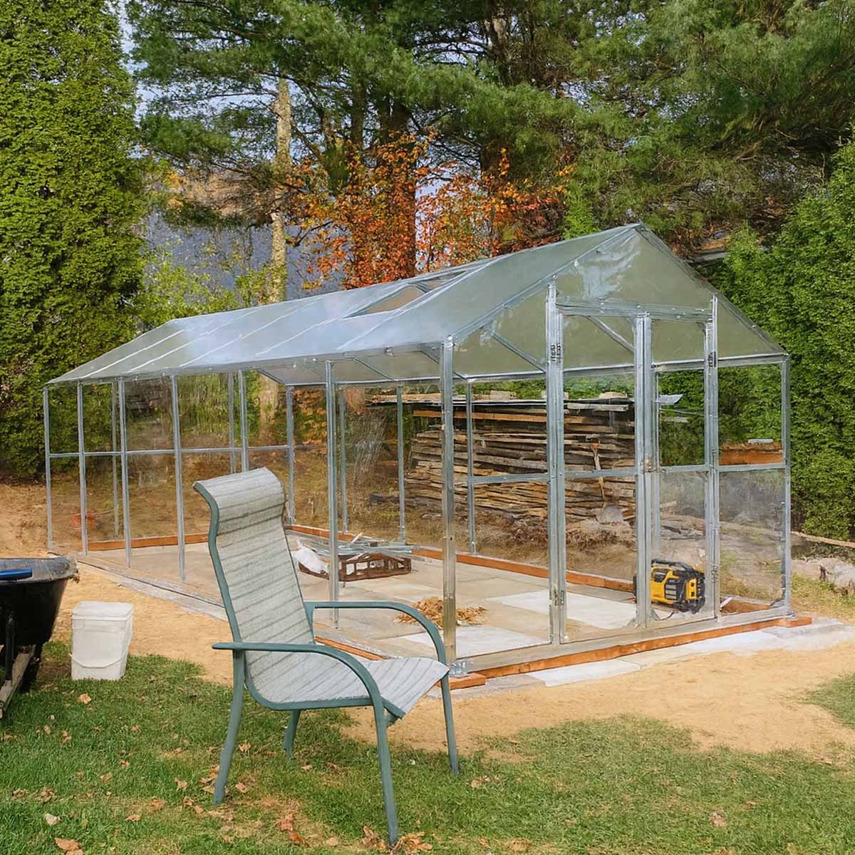 Metal framed portable greenhouse with clear poly panels and wood base - Cliffhouse Buildings TMG-GH811 8' x 10' Greenhouse Kit with Galvanized Steel Frame, TMG Heavy Series™, Polycarb Roof and Crystal-Clear Walls