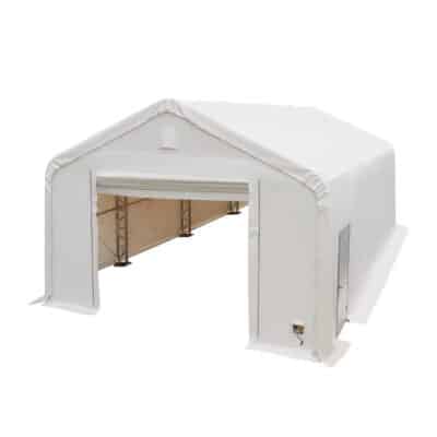 Large white portable tent with a roll-up door and exposed metal frame inside, used as a temporary shelter or storage space