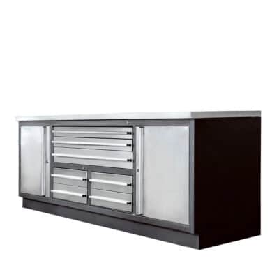 Metal tool chest with multiple drawers and side cabinets on a dark base, set in a workshop style.