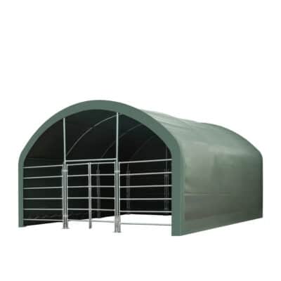 Green arched shelter with metal gate pens for housing livestock/animals in a temporary barn setting
