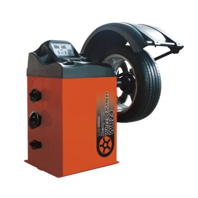 Orange Balancer rotating skid steer attachment with large pneumatic tires and hydraulic grapple-style tool fork